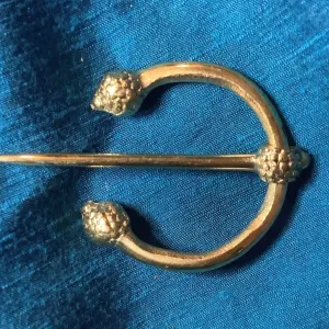 Penannular Brooch with Thistle Terminals