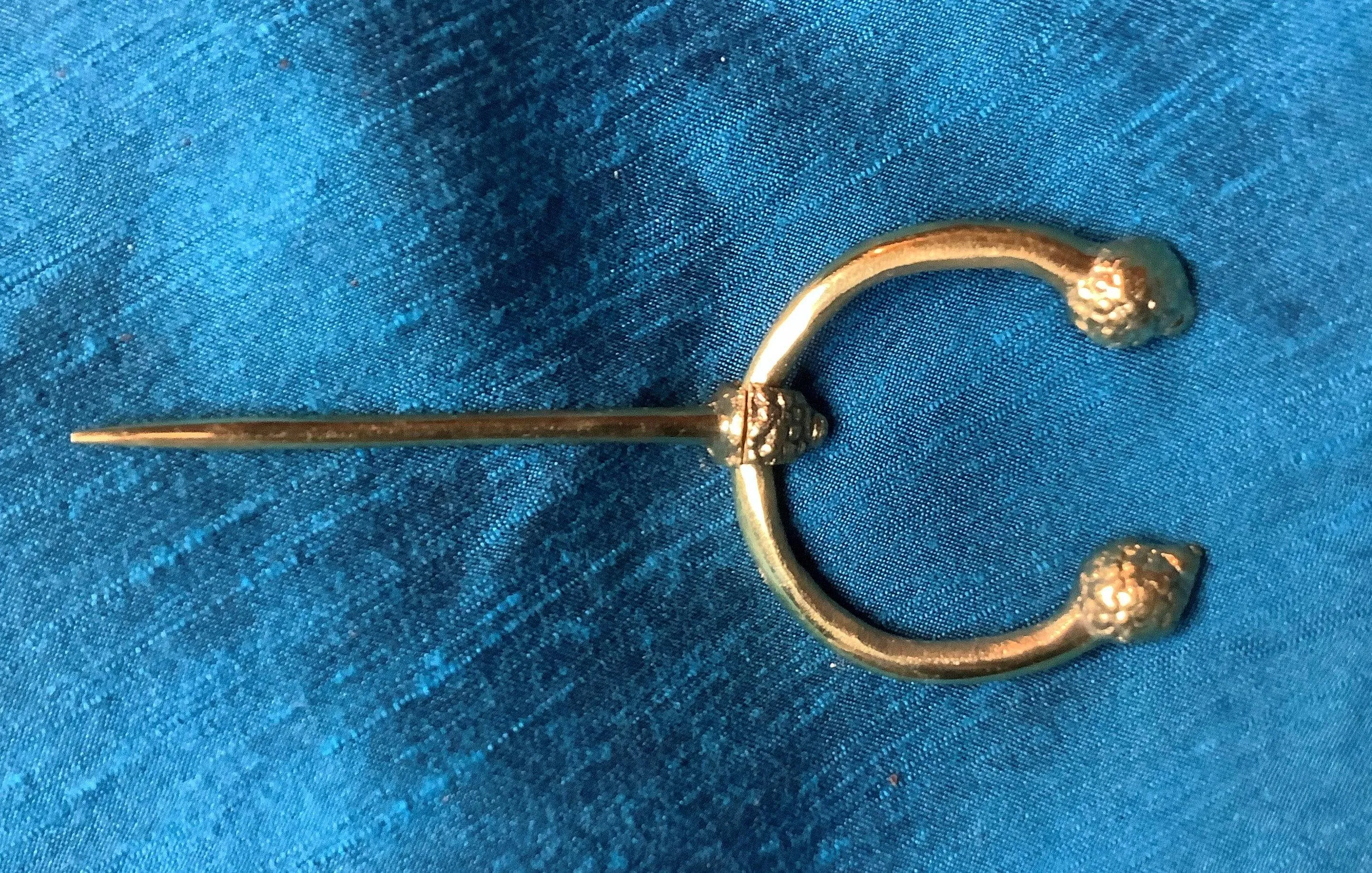 Penannular Brooch with Thistle Terminals