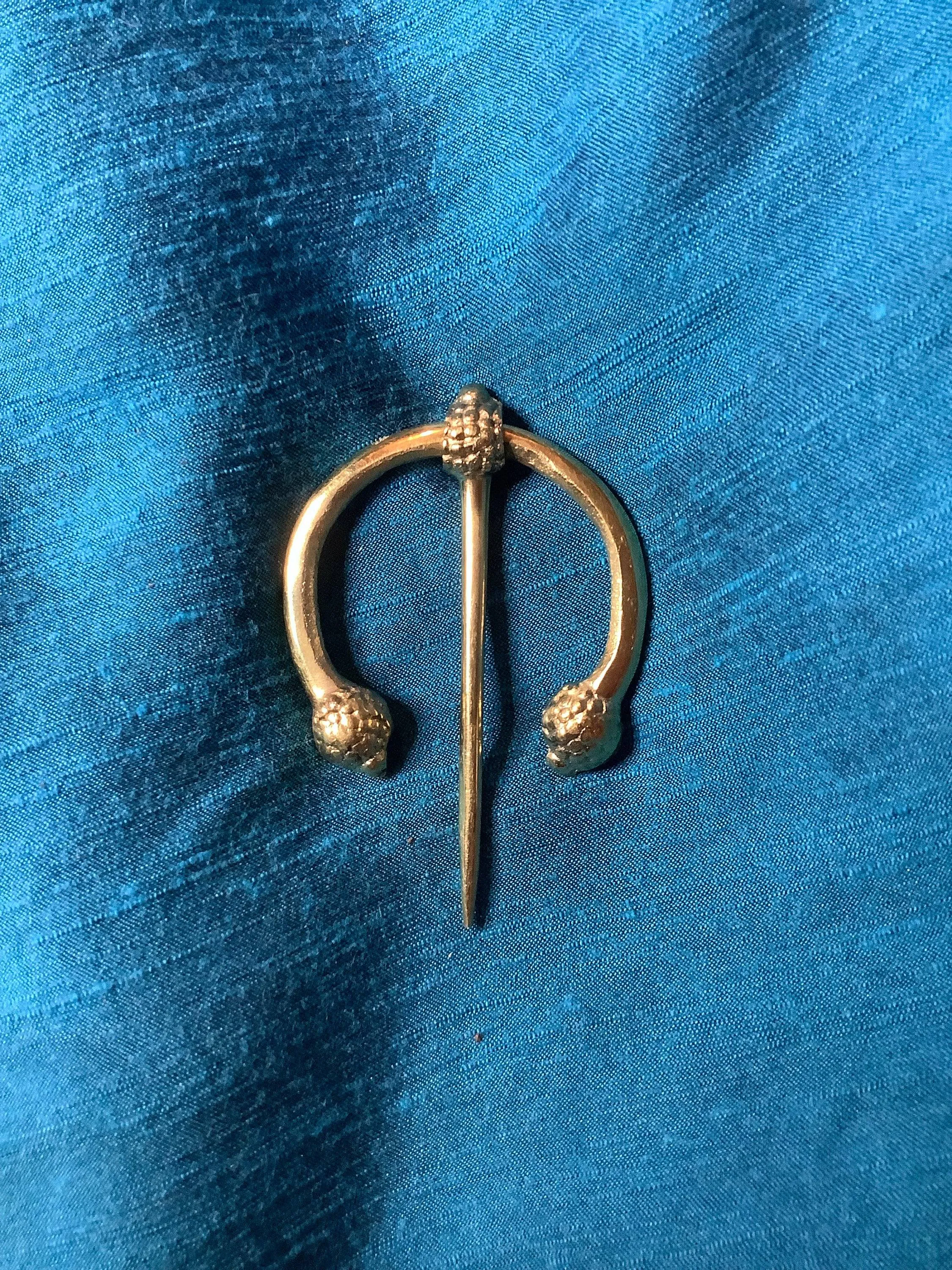 Penannular Brooch with Thistle Terminals